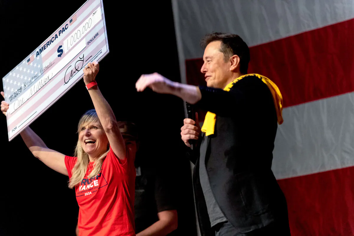 SpaceX and Tesla founder Elon Musk awards Kristine Fishell with a $1 million check during the town hall at the Roxain Theater in Pittsburgh, Pa., on Oct. 20, 2024. (Michael Swensen/Getty Images)