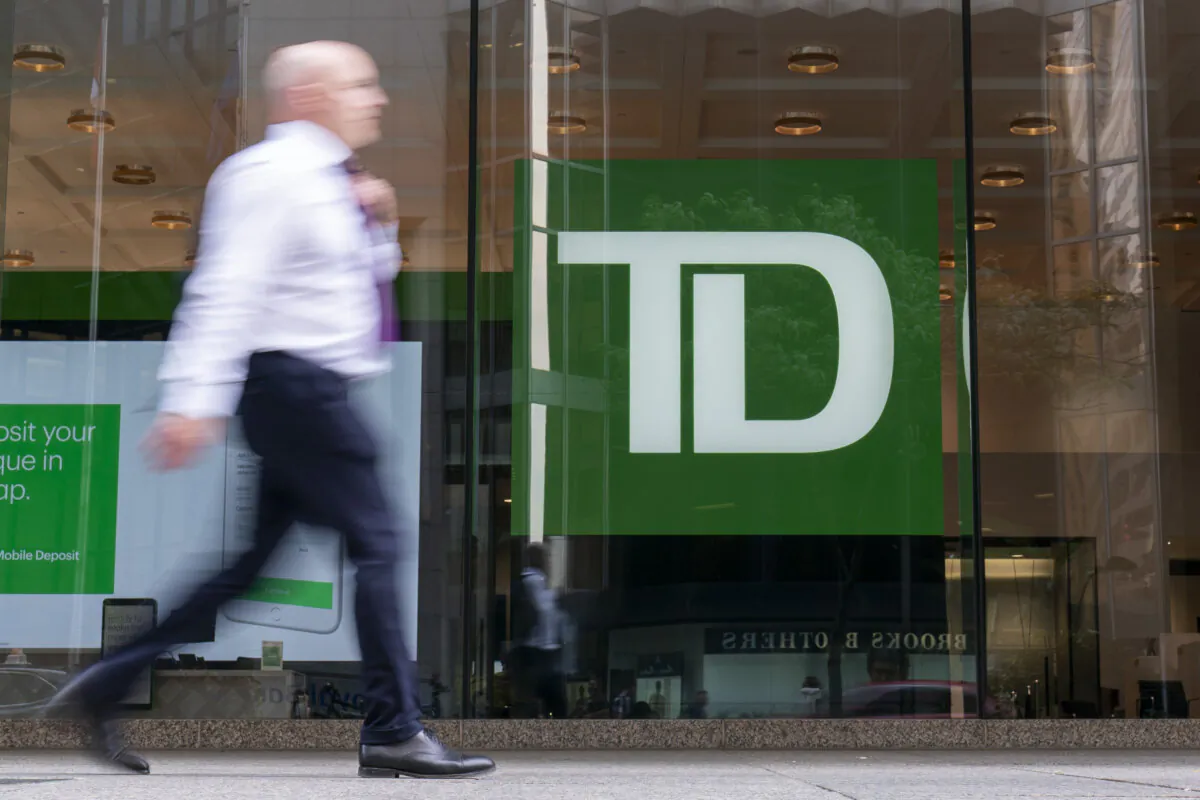 A man walks past a Toronto-Dominion Bank in the financial district of Toronto on Aug. 14, 2023. (The Canadian Press/Spencer Colby)