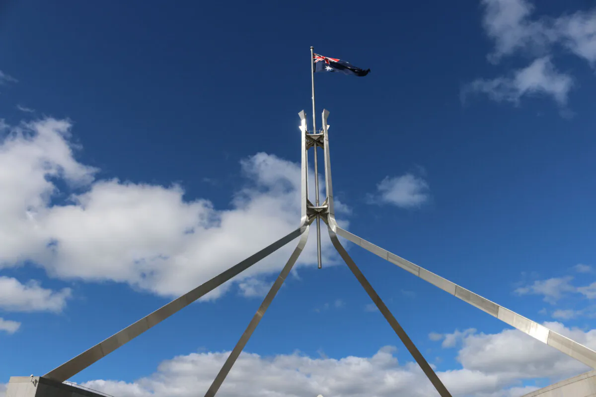 An Australian flag flies atop Parliament House in Canberra, Australia, on Feb. 8, 2024. (Melanie Sun/The Epoch Times)