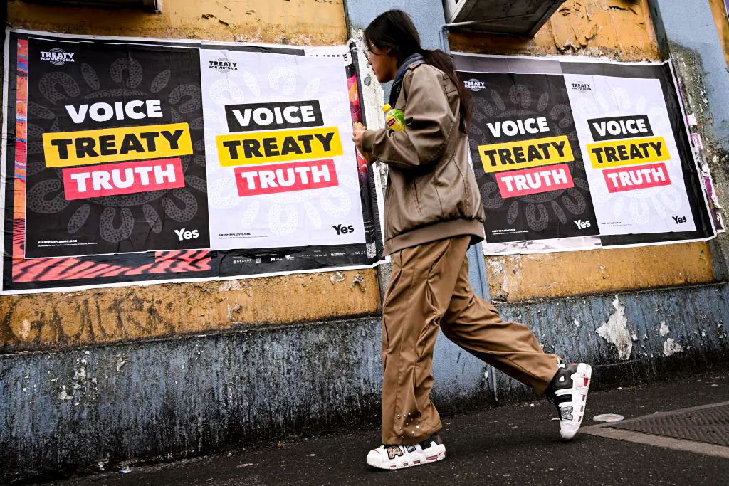 A woman walks past posters advocating for an Aboriginal voice and treaty ahead of an upcoming referendum in Melbourne, Australia on Aug. 30, 2023. (William West/AFP via Getty Images)