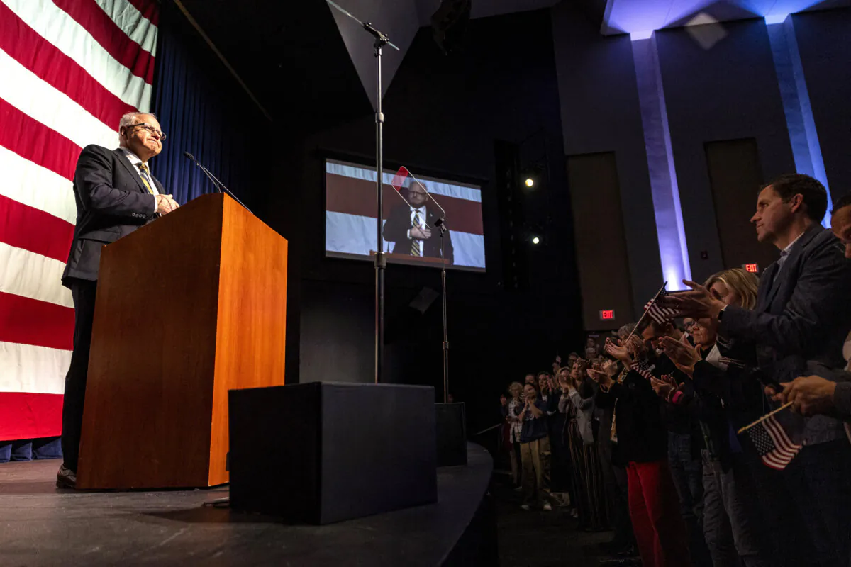 Minnesota Gov. Tim Walz receives a standing ovation while speaking at Eagan High School in Eagan, Minn., on Nov. 8, 2024. (Ayrton Breckenridge/Star Tribune via AP)