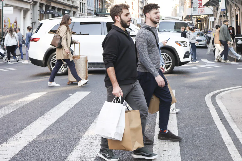 People carry shopping bags as they walk through SoHo in New York City on Oct. 30, 2024. (Michael M. Santiago/Getty Images)
