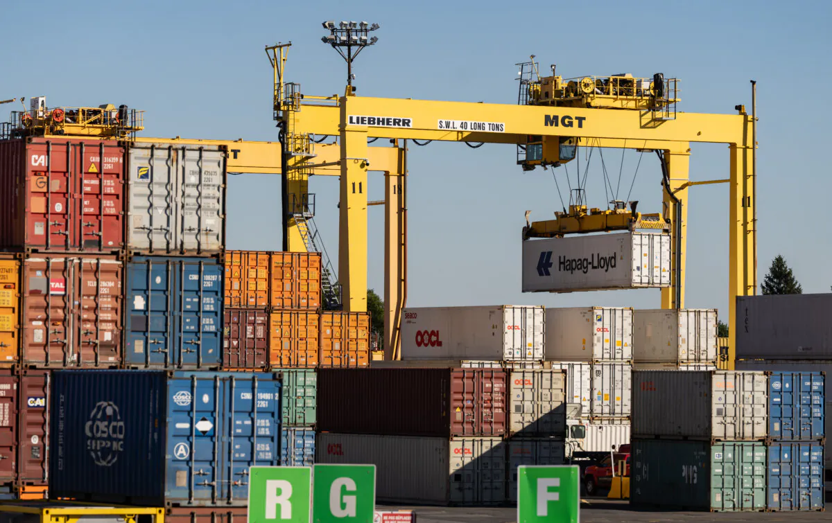 Shipping containers are moved in the Port of Montreal on Sept. 30, 2024. (The Canadian Press/Christinne Muschi)