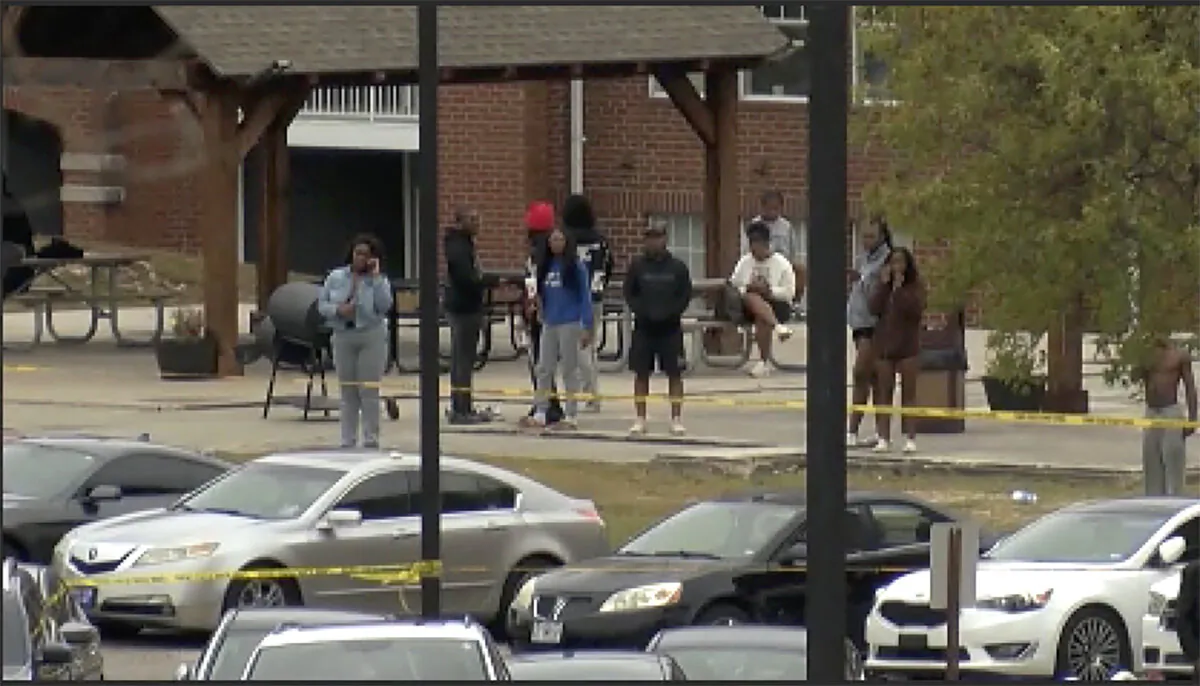 People stand near the scene of an earlier shooting at Tuskegee University in Tuskegee, Ala., on Nov. 10, 2024. (WSFA via AP)