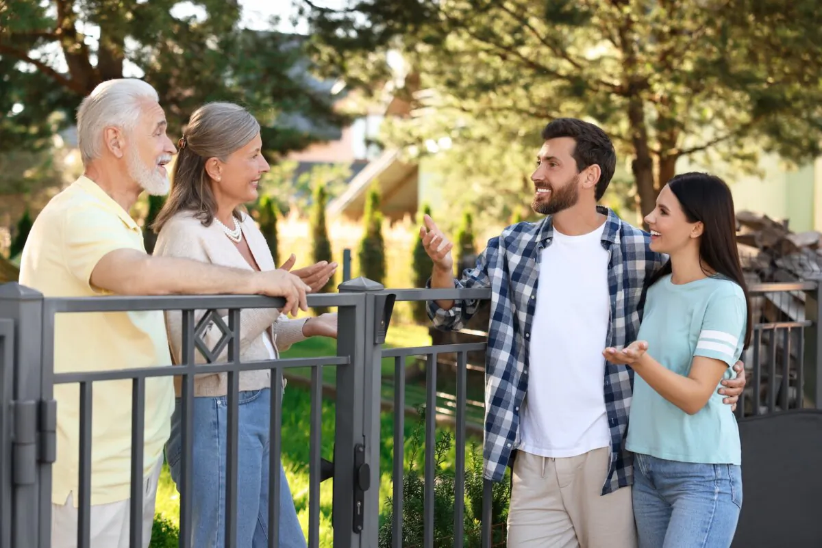 A smile is a good place to start for building a healthy neighborly relationship. (New Africa/Shutterstock)