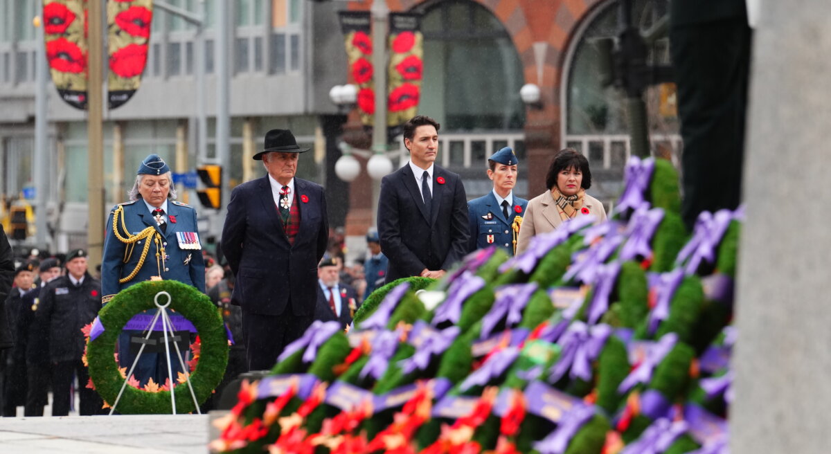 Gov. Gen. Mary Simon, (left to right) her husband Whit Fraser, Prime Minister Justin Trudeau and Veterans Affairs Minister Ginette Petitpas Taylor attend a Remembrance Day ceremony at the National War Memorial in Ottawa on Nov. 11, 2024. (Sean Kilpatrick/The Canadian Press)