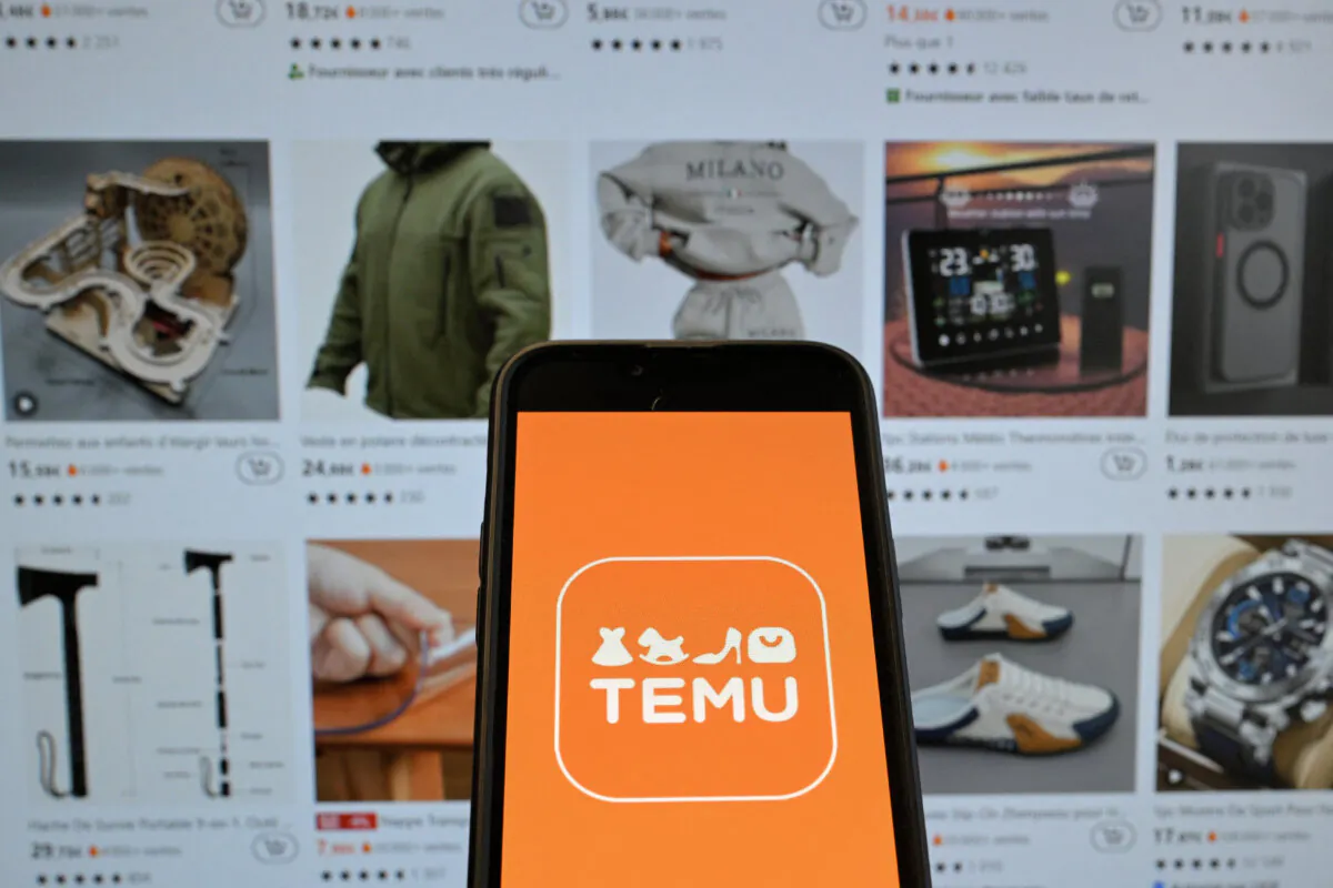 The logo of Chinese e-commerce company Temu displayed on a mobile phone holding in front of a screen bearing a website page of the e-commerce company, in Brussels, on Nov. 4, 2024. (Nicolas Tucat/AFP via Getty Images)