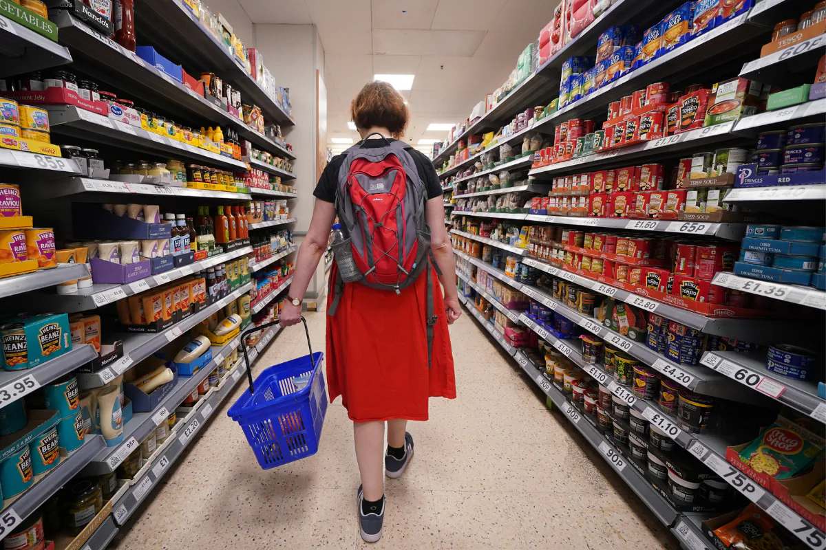 A shopper walking through the aisle of a Tesco supermarket in London, England, on Sept. 3, 2022. (Yui Mok/PA Wire)