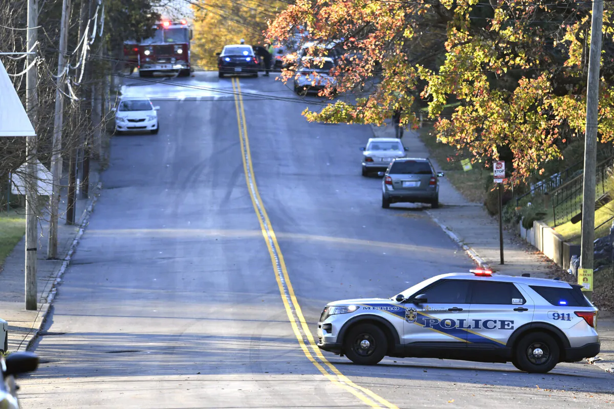 Members of the Louisville Metro Police and Louisville Fire Departments block access to Givaudan Sense Colour following an explosion at the facility in Louisville, Ky., on Nov. 12, 2024. (Timothy D. Easley/AP Photo)