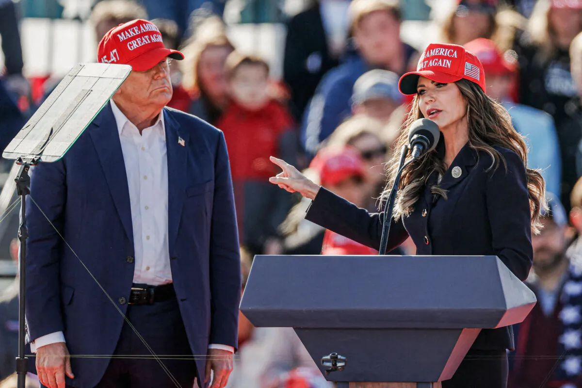 Former President Donald Trump listens as South Dakota Gov. Kristi Noem speaks during a rally in Vandalia, Ohio, on March 16, 2024. (Kamil Krzacynski/AFP via Getty Images)