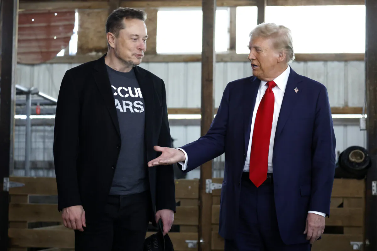 Republican presidential nominee, former President Donald Trump offers his hand to Tesla founder Elon Musk back stage during a campaign rally at the Butler Farm Show grounds, in Butler, Pa., on Oct. 5, 2024. (Anna Moneymaker /Getty Images)