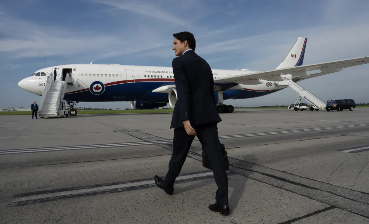 Prime Minister Justin Trudeau makes his way to a government plane for a departure from the airport, in Ottawa, on July 8, 2024. (The Canadian Press/Adrian Wyld)