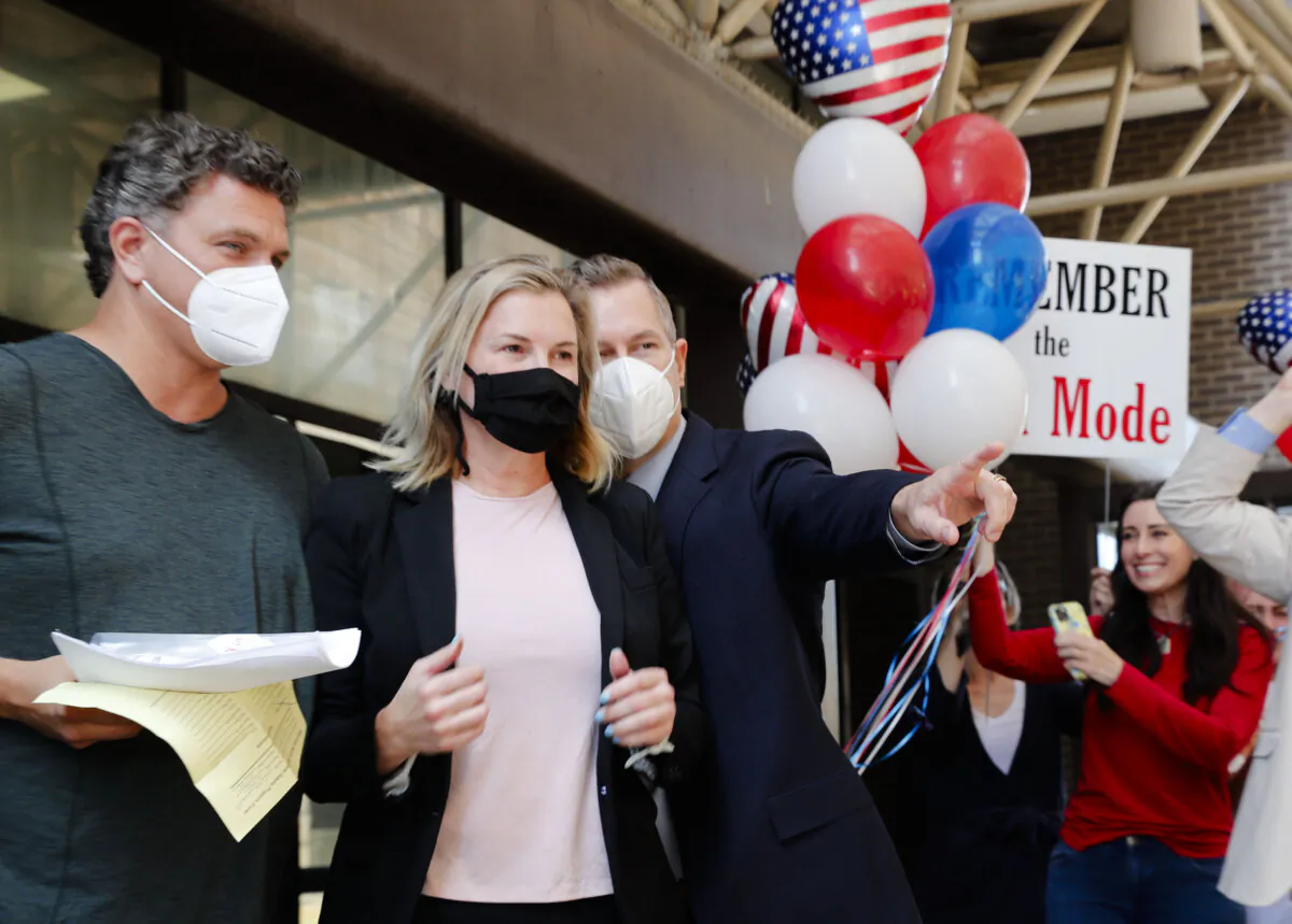 Salon owner Shelley Luther (C) walks with her boyfriend, Tim Georgeff (L), and lawyer Warren Norred (R) after she was released from jail in Dallas on May 7, 2020. (LM Otero/AP Photo)