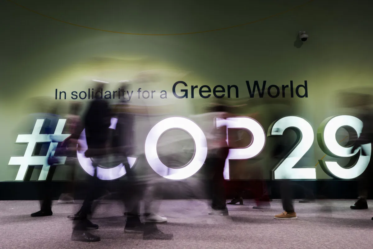 People walk through the venue hosting the COP29 U.N. Climate Summit in Baku, Azerbaijan, on Nov. 13, 2024. (AP Photo/Rafiq Maqbool)