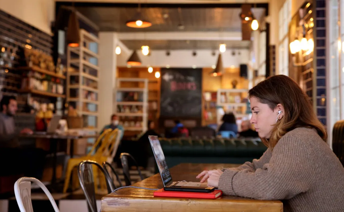 A woman sits with her laptop at a cafe in Beirut, Lebanon, on Jan. 14, 2022. (Joseph Eid/AFP via Getty Images)
