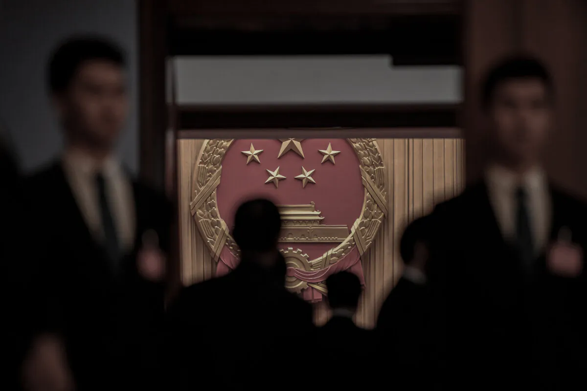 Security guards stand at an entrance to the Great Hall of the People during the sixth plenary session of China's rubber-stamp legislature, the National People's Congress, at the Great Hall of the People in Beijing on March 18, 2018. (Greg Baker/AFP via Getty Images)