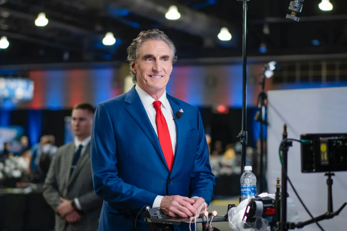 North Dakota Gov. Doug Burgum prepares for a TV interview at the media filing center and spin room at the Pennsylvania Convention Center ahead of the presidential debate between Republican nominee former President Donald J. Trump and Democratic nominee Vice President Kamala Harris in Philadelphia, Pa., on Sept. 10, 2024. (Madalina Vasiliu/The Epoch Times)