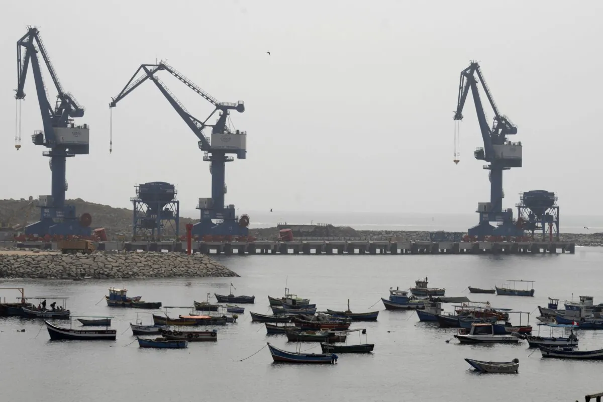 View of traditional fishing boats anchored in the town's harbor with the Chancay "megaport" cranes in the background, north of the Peruvian capital Lima on Oct. 29, 2024. (Cris Bouroncle/AFP via Getty Images)