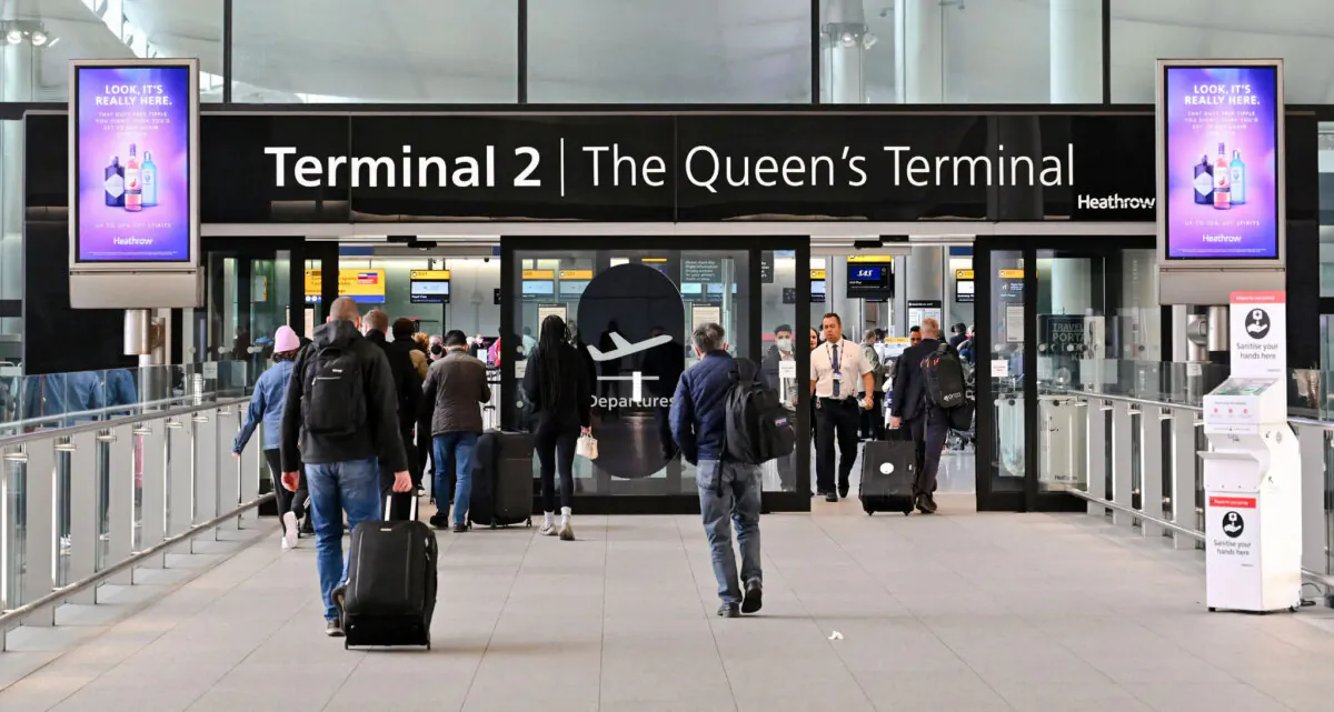 Travellers arrive at Terminal 2 of London Heathrow Airport in London on April 6, 2022. (Justin Tallis/AFP via Getty Images)