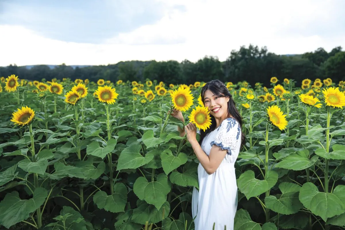 Cynthia Sun photographed at a sunflower field in upstate New York. Sunflowers are among her favorite flowers. (Samira Bouaou for American Essence)