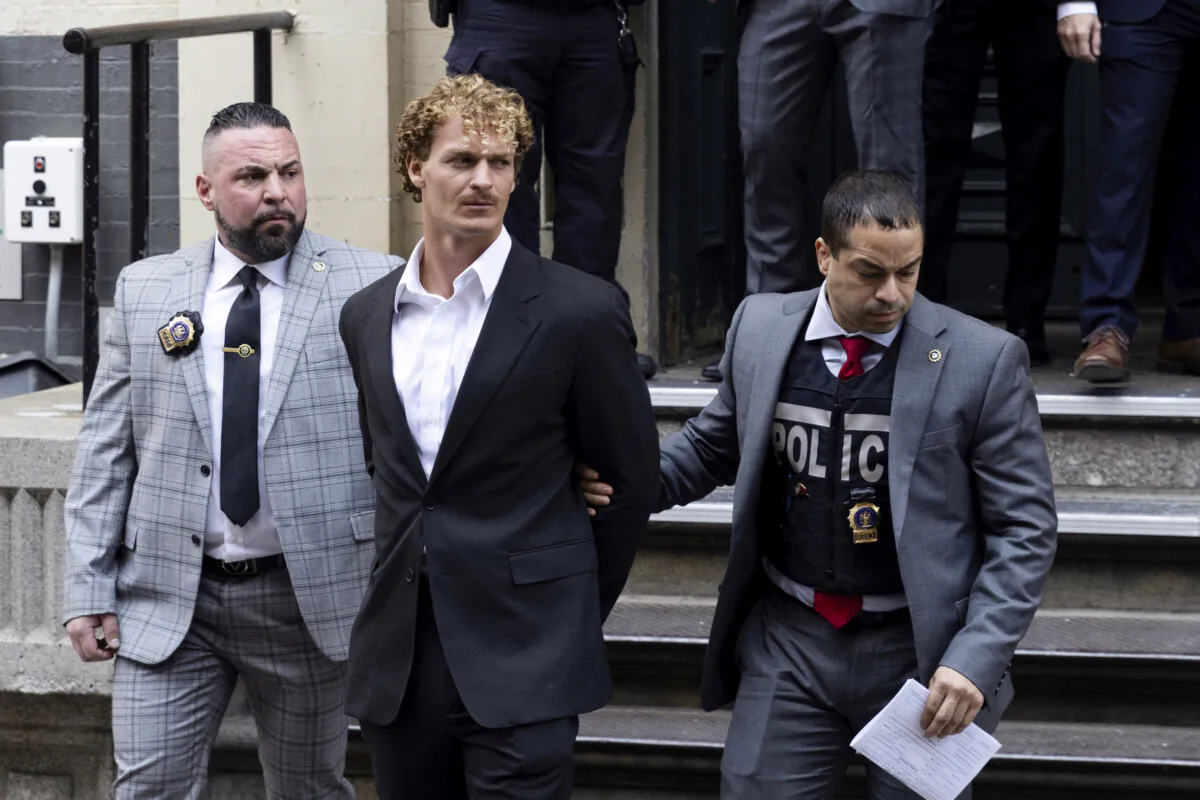 Daniel Penny (C) is walked by New York Police Department detectives out of the 5th Precinct in New York on May 12, 2023. (Jeenah Moon/AP Photo)