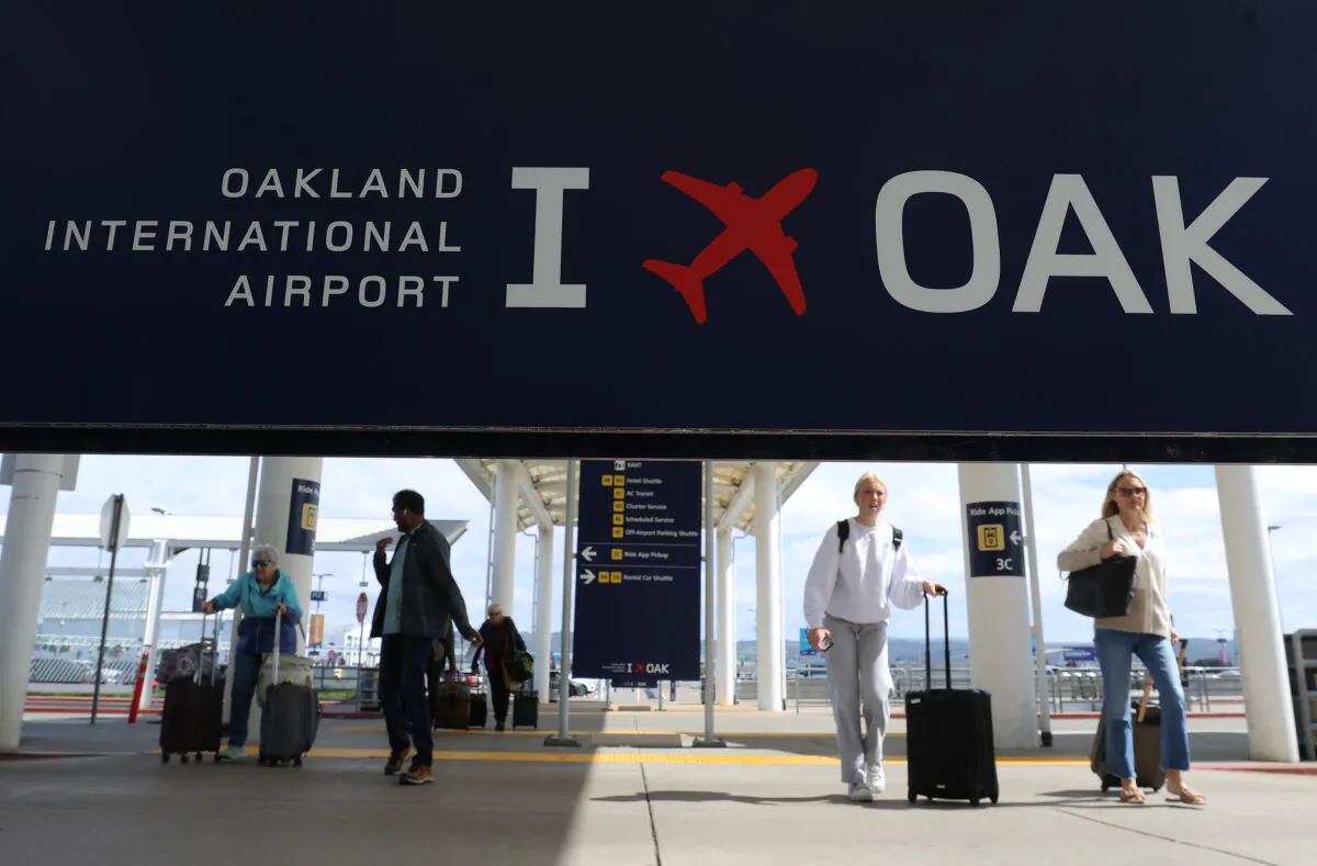 Travelers walk towards Terminal 2 at Oakland International Airport in California on April 12, 2024. (Justin Sullivan/Getty Images)