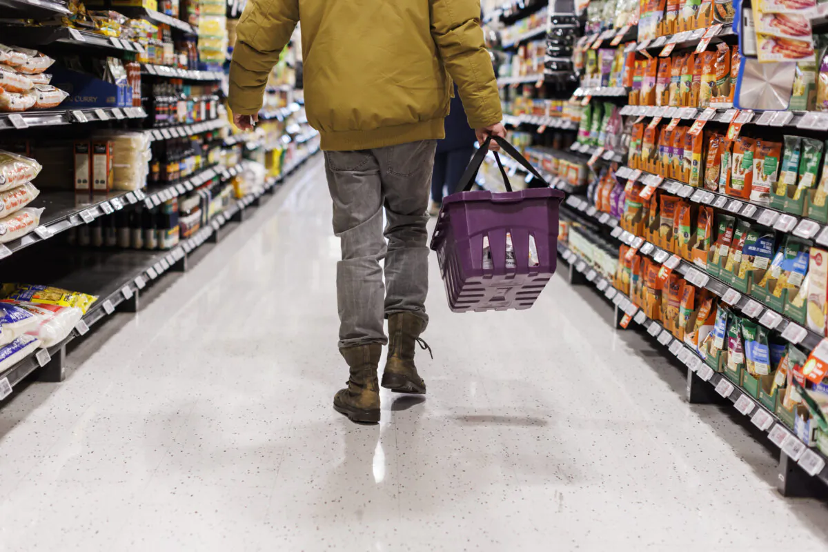A customer browses an aisle at a grocery store in Toronto on Feb. 2, 2024. (The Canadian Press/Cole Burston)