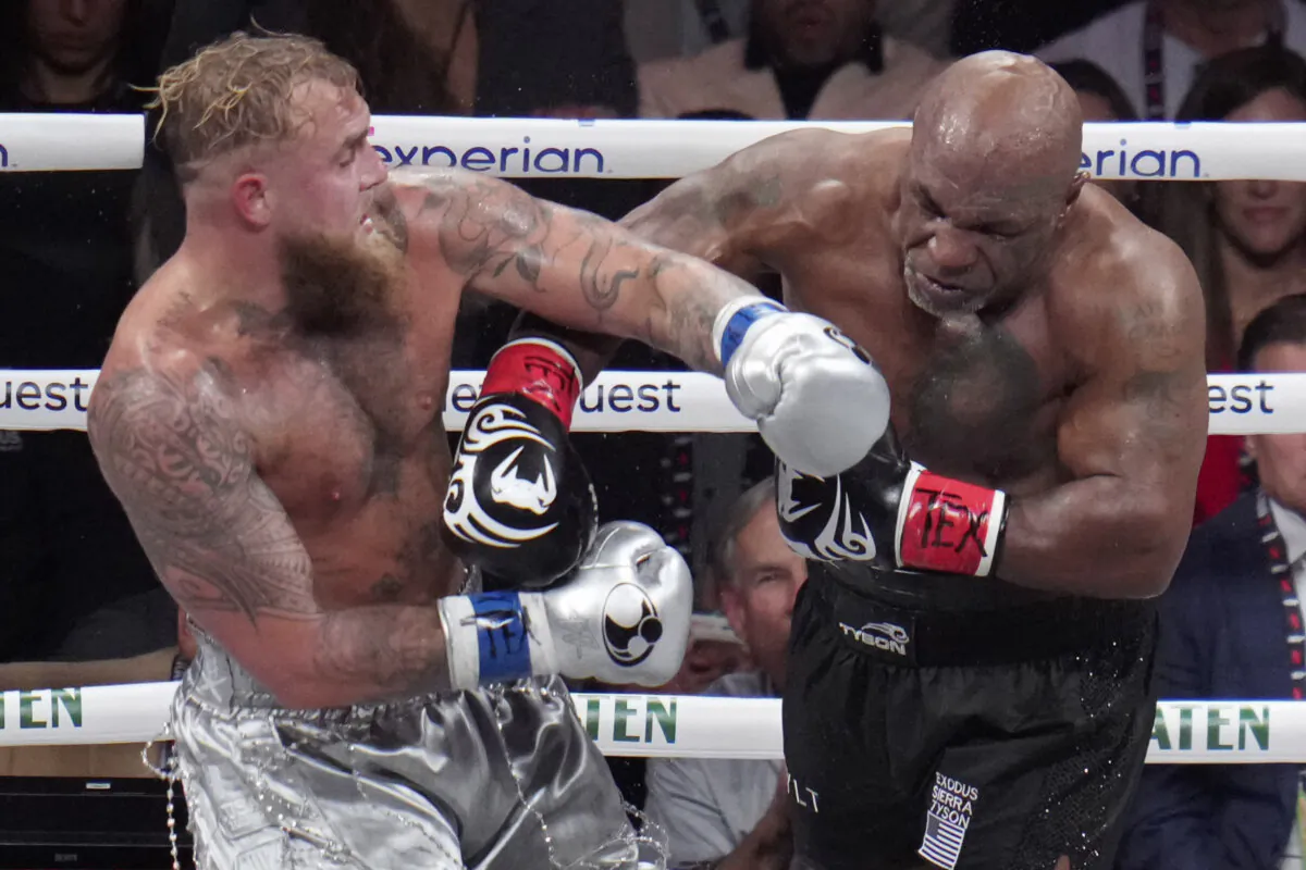 Jake Paul, (L), fights Mike Tyson during their heavyweight boxing match, in Arlington, Texas, on Nov. 15, 2024. (Julio Cortez/AP Photo)