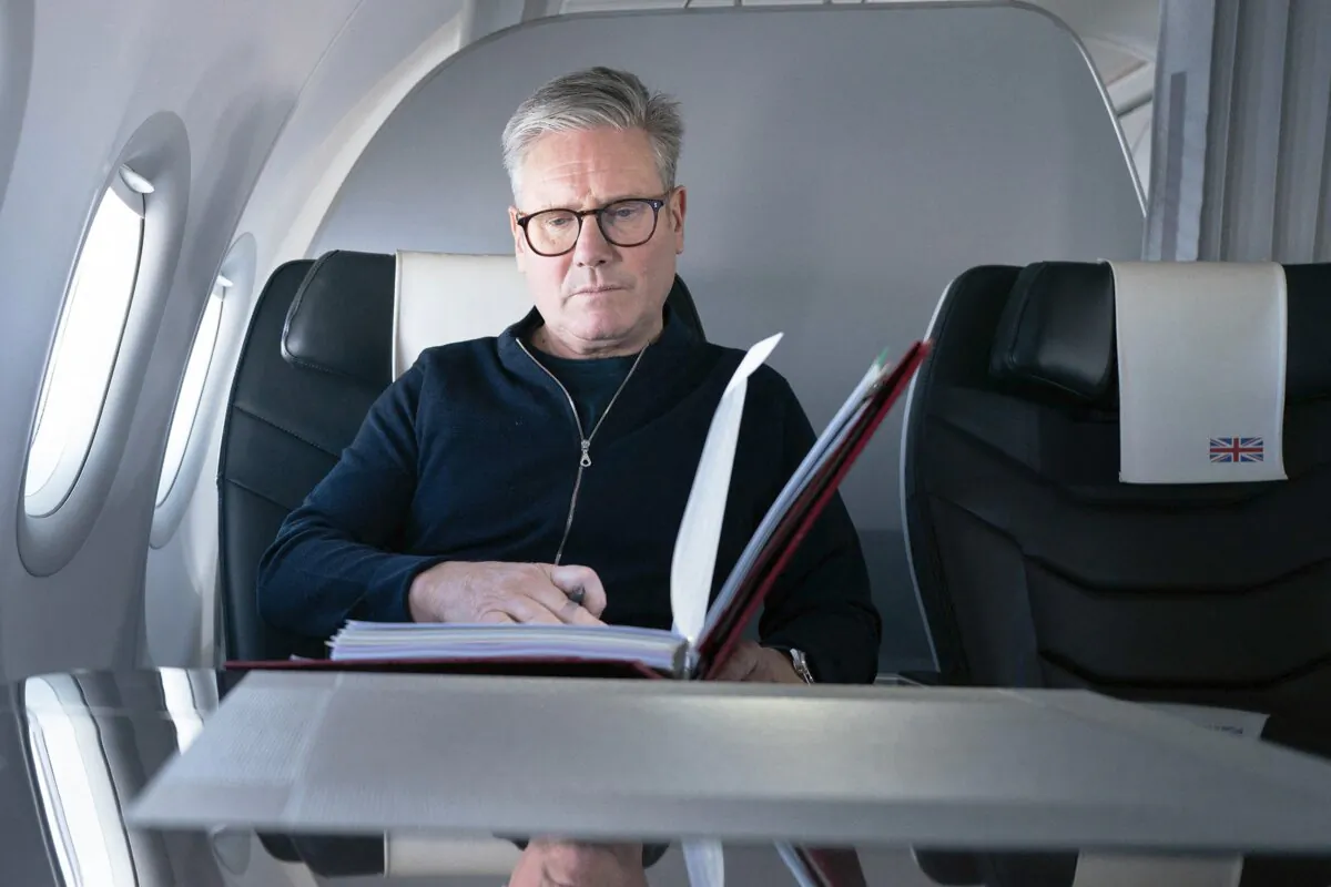 British Prime Minister Sir Keir Starmer poses for a photograph as he  works while traveling on a government aeroplane en route to attend the G20 summit in Rio de Janeiro, Brazil, on Nov. 17, 2024. (Stefan Rousseau/Pool/AFP via Getty Images)