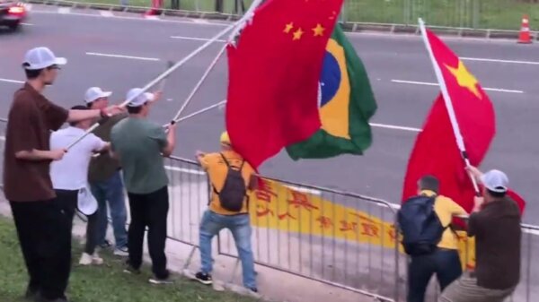 Screenshot from video provided to The Epoch Times shows Chinese protesters trying to stop Falun Gong practitioners from displaying a banner about the spiritual discipline, in Rio de Janeiro, Brazil, on Nov. 17 2024.