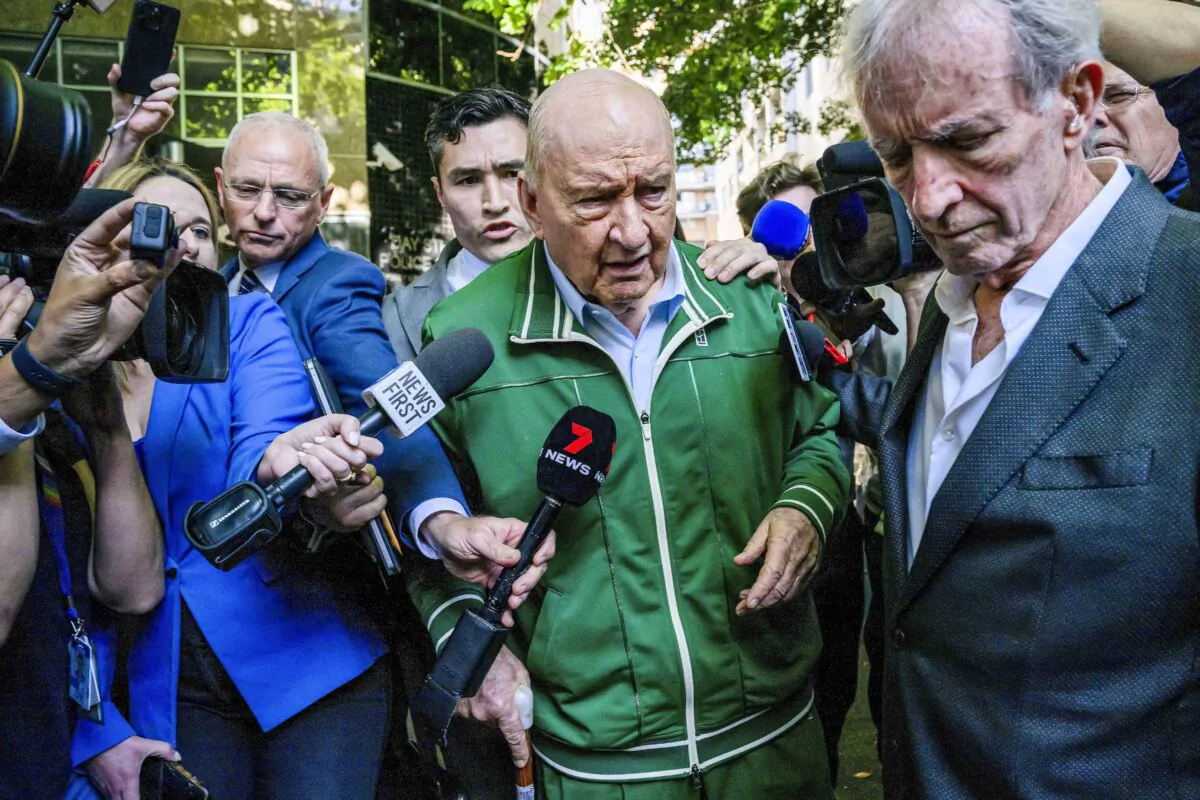 Retired Sydney broadcaster and former Australian national rugby coach Alan Jones, centre, walks past waiting media as he leaves a police station in Sydney, Australia on Nov. 18, 2024. (Bianca De Marchi/AAP Image via AP)