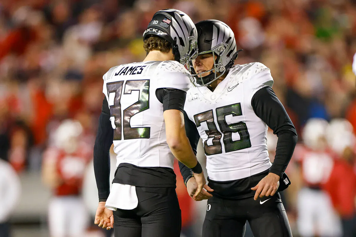 Atticus Sappington #36 and Ross James #92 of the Oregon Ducks react after making a 24-yard field goal to take the lead in the fourth quarter against the Wisconsin Badgers at Camp Randall Stadium in Madison, Wis. on Nov. 16, 2024. (John Fisher/Getty Images)