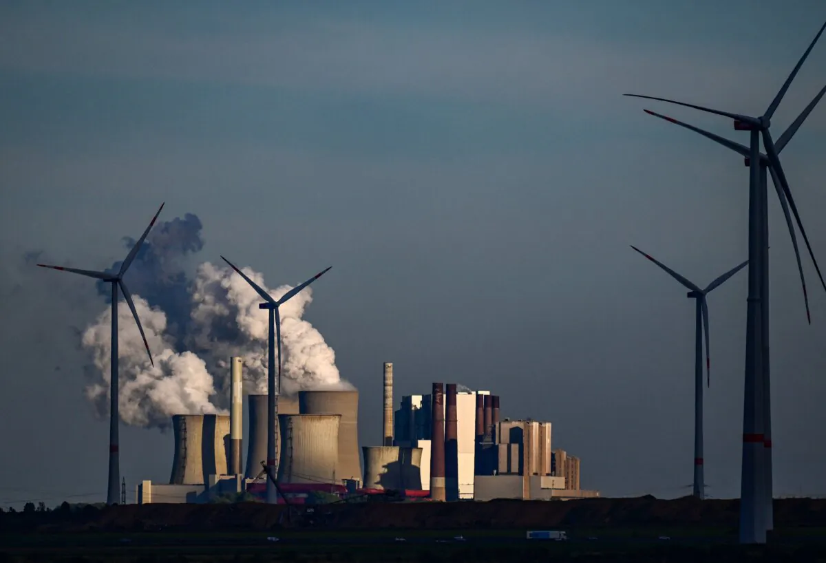 Wind turbines in front of the lignite-fired Niederaussem power plant in Niederaussem, Western Germany, on Oct. 5, 2022. (Ina Fassbender/AFP via Getty Images)
