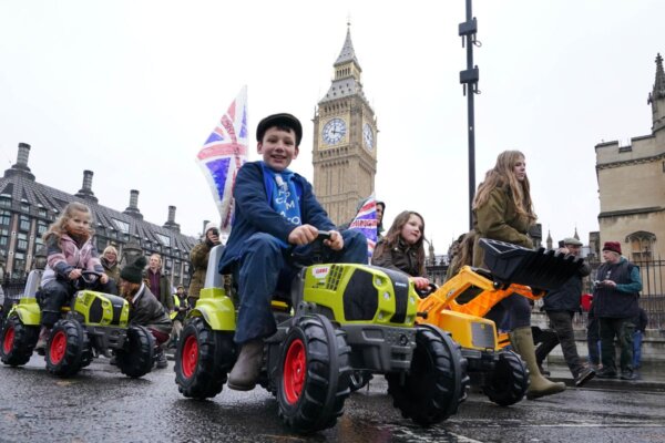 Children on toy tractors during a farmers protest against inheritance tax in London, England, on Nov. 19, 2024. (Gareth Fuller/PA Wire)
