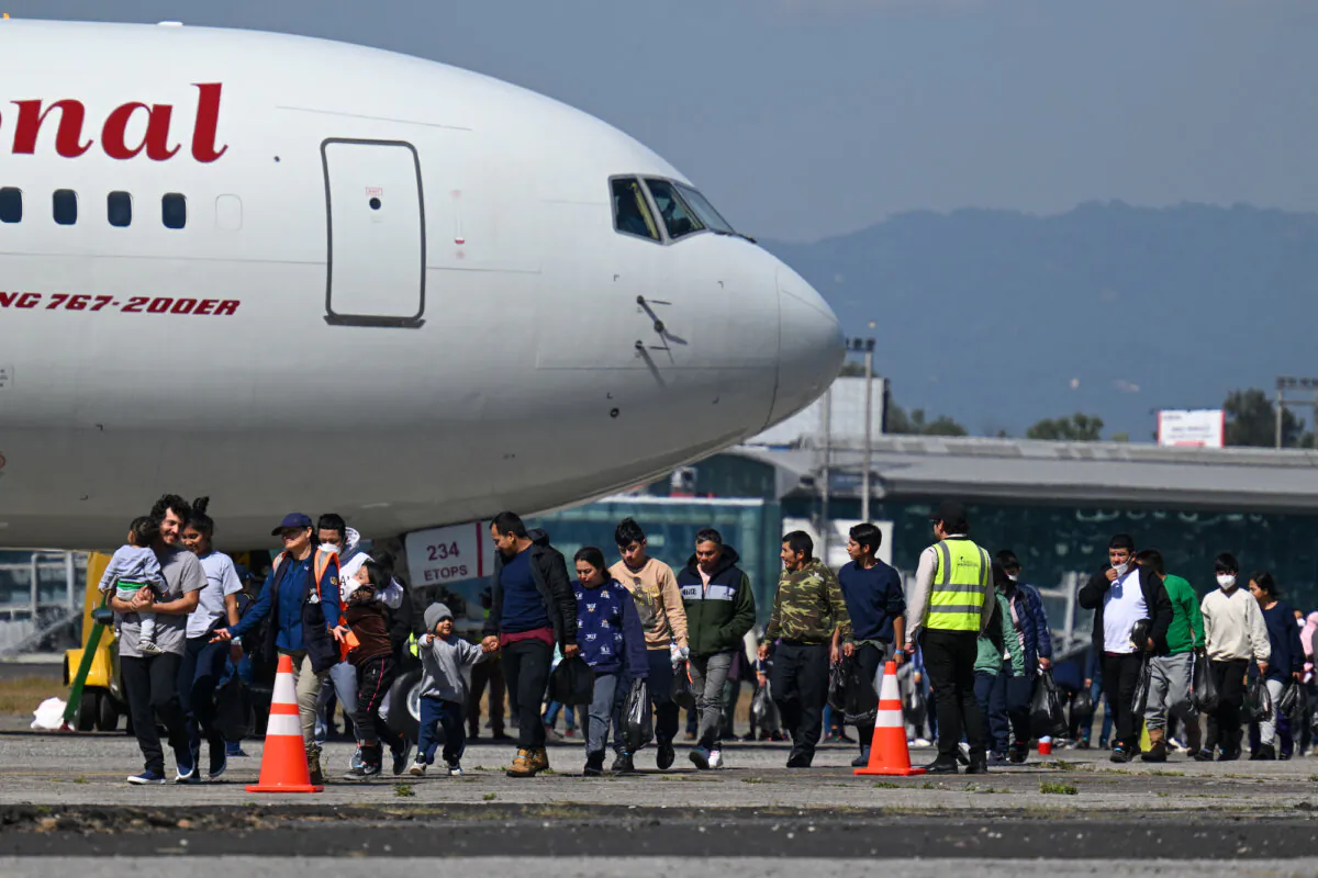 Guatemalans deported from the United States walk on the tarmac after landing at a Guatemalan Air Force base in Guatemala City in the first flight of deportees of the year on January 3, 2024. (Johan Ordonez/AFP)