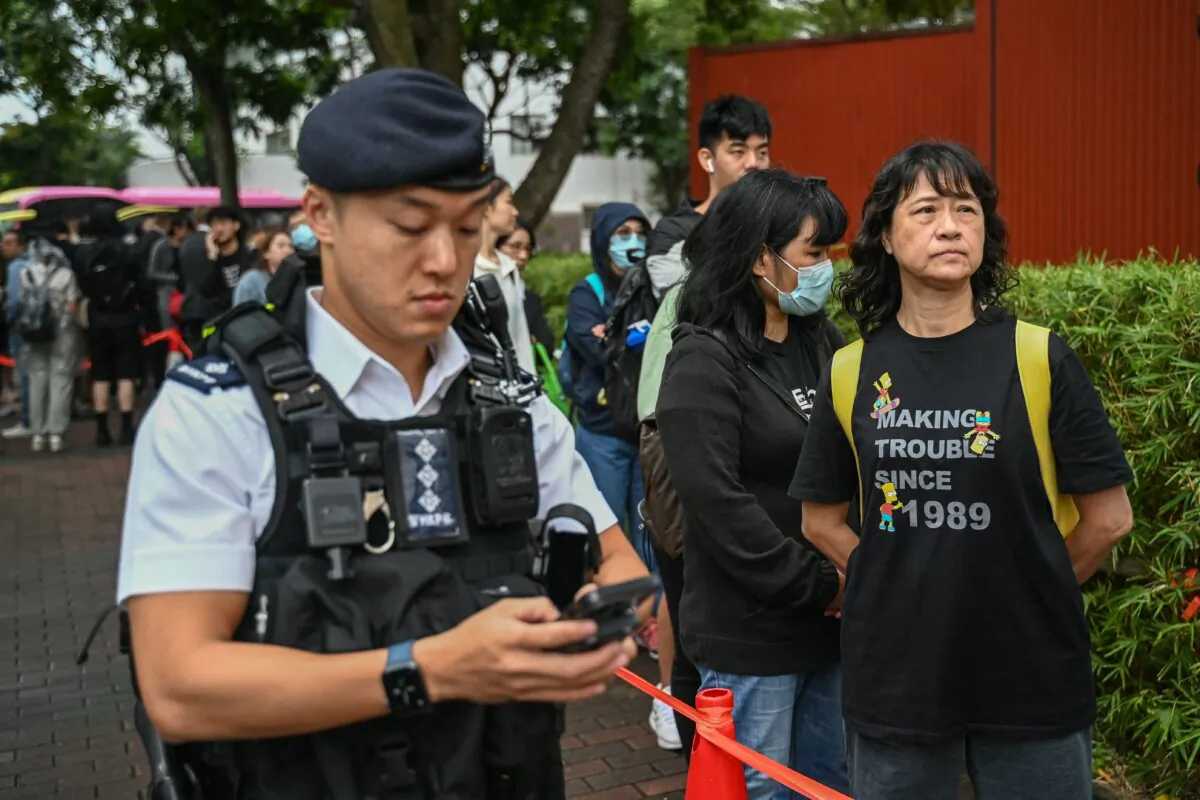 People queue outside the West Kowloon Magistrates' Court in Hong Kong on Nov. 19, 2024. (Peter Parks/AFP via Getty Images)