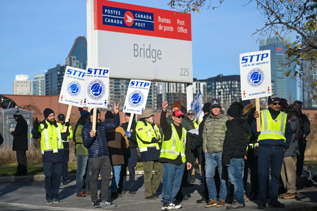 Canada Post workers picket outside a sorting plant in Montreal on Nov.15, 2024. (The Canadian Press/Graham Hughes)
