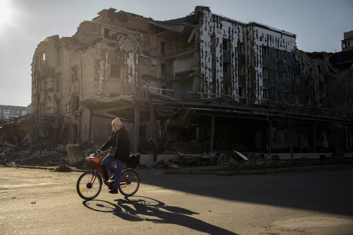 A local resident cycles past destroyed shop and restaurant in the town of Pokrovsk, Donetsk region, on Nov. 19, 2024. (Florent Vergnes/AFP via Getty Images)