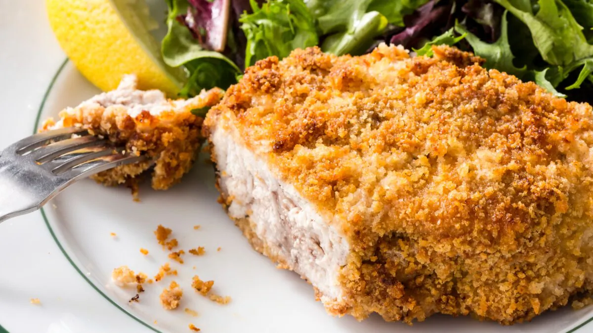 A squeeze from a lemon wedge adds a pleasant brightness to the pork chop. (Joe Keller/Keller + Keller/TCA)