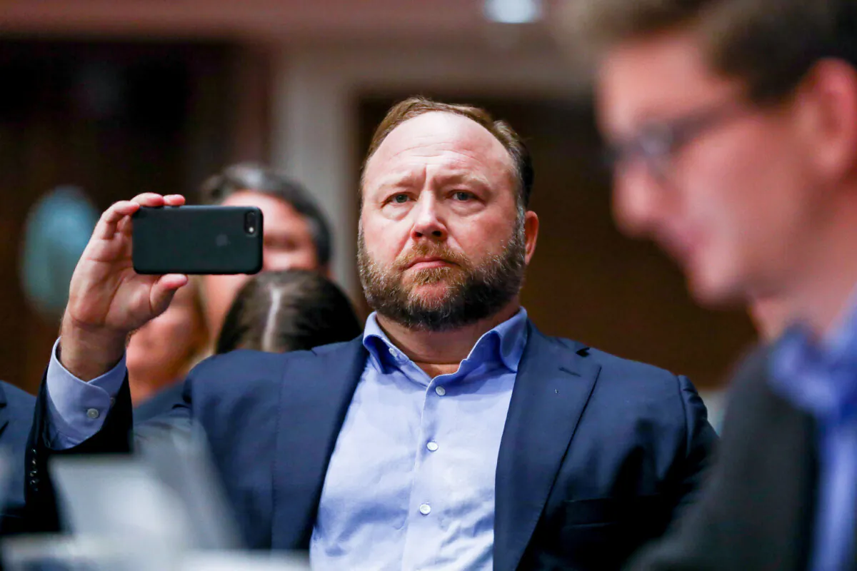 InfoWars founder Alex Jones takes photos at a hearing to examine foreign influence operations' use of social media platforms before the Intelligence Committee at the Capitol in Washington, on Sept. 5, 2018. (Samira Bouaou/The Epoch Times)