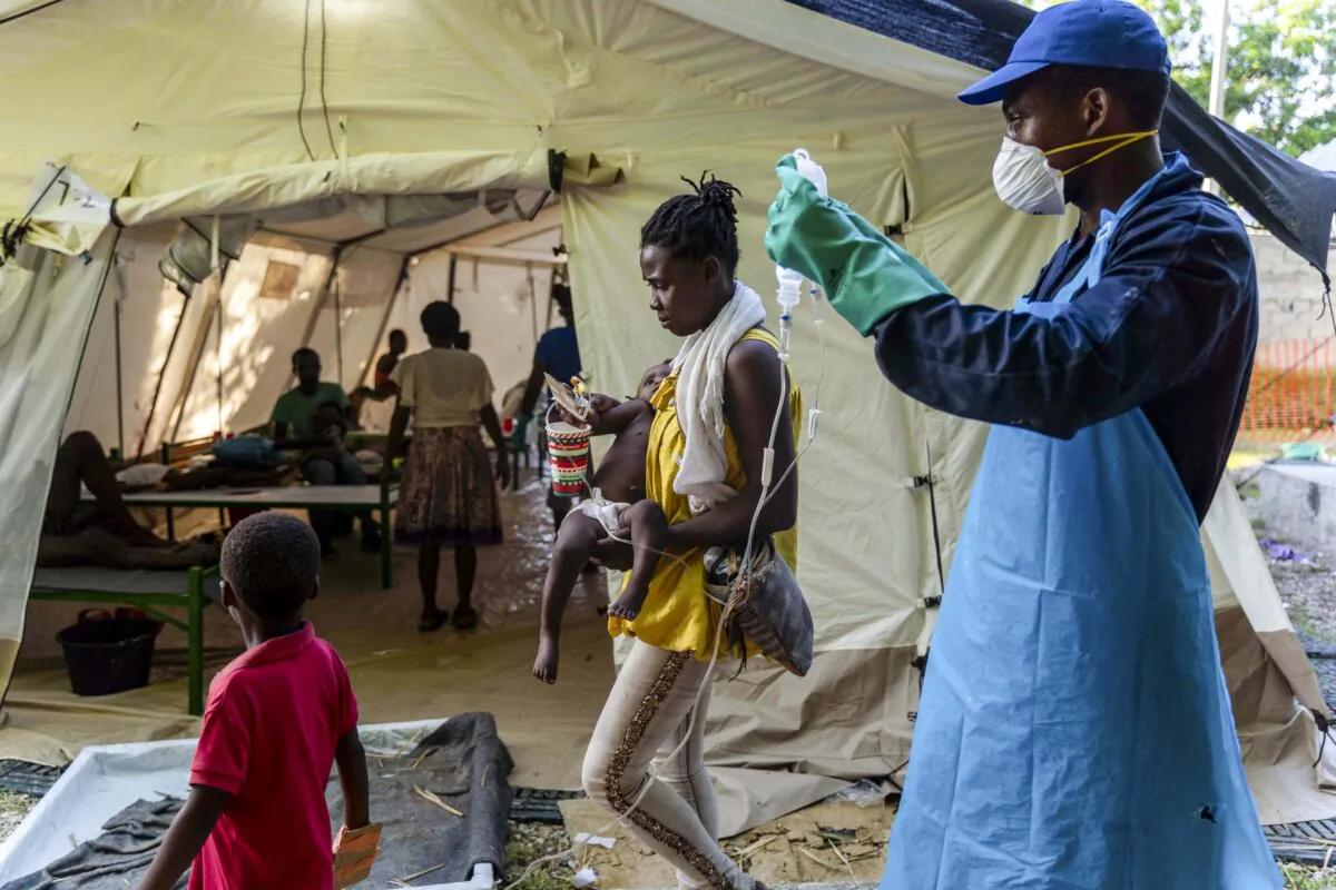 A woman brings her child to a clinic run by Doctors Without Borders in Cité Soleil a densely populated commune of Port-au-Prince, Haiti, on Oct. 7, 2022. (Richard Pierrin/AFP via Getty Images)