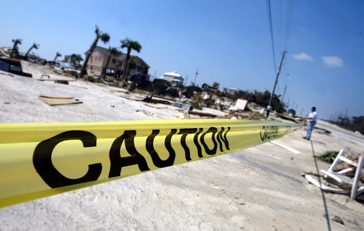 Orange Beach police officers put up caution tape near a collapsed building in Orange Beach, Ala., on Sept. 18, 2004. (Justin Sullivan/Getty Images)