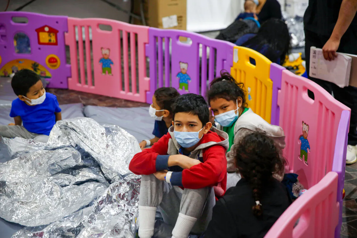 Unaccompanied migrant children, ranging in age from 3 to 9 years old, sit inside a playpen at a U.S. Customs and Border Protection facility in Donna, Texas, on March 30, 2021. (Dario Lopez-Mills/AP Photo/Pool)