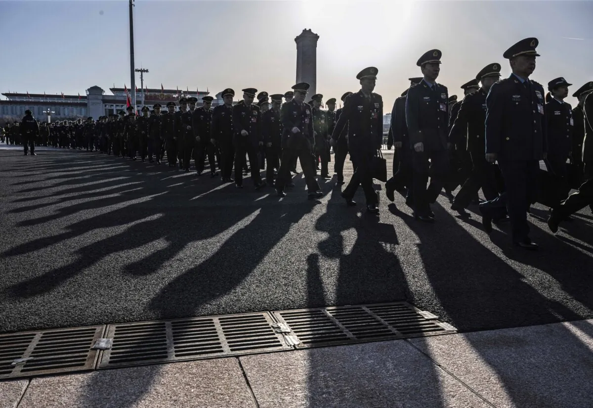 Chinese military delegates arrive at the second plenary session of the National Peoples Congress at the Great Hall of the People in Beijing on March 8, 2024. (Kevin Frayer/Getty Images)
