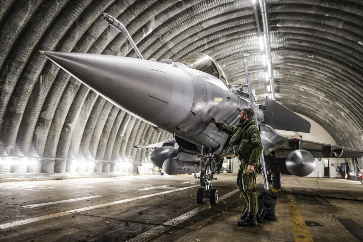 A Rafale jet fighter pilot prepares his aircraft before leaving for a four-month mission to protect the airspace of the Baltic States, as France is deploying four Rafale fighters to Lithuania under NATO mandate, in Mont-de-Marsan, France, on Nov. 25, 2022. (Thibaud Moritz/AFP via Getty Images)