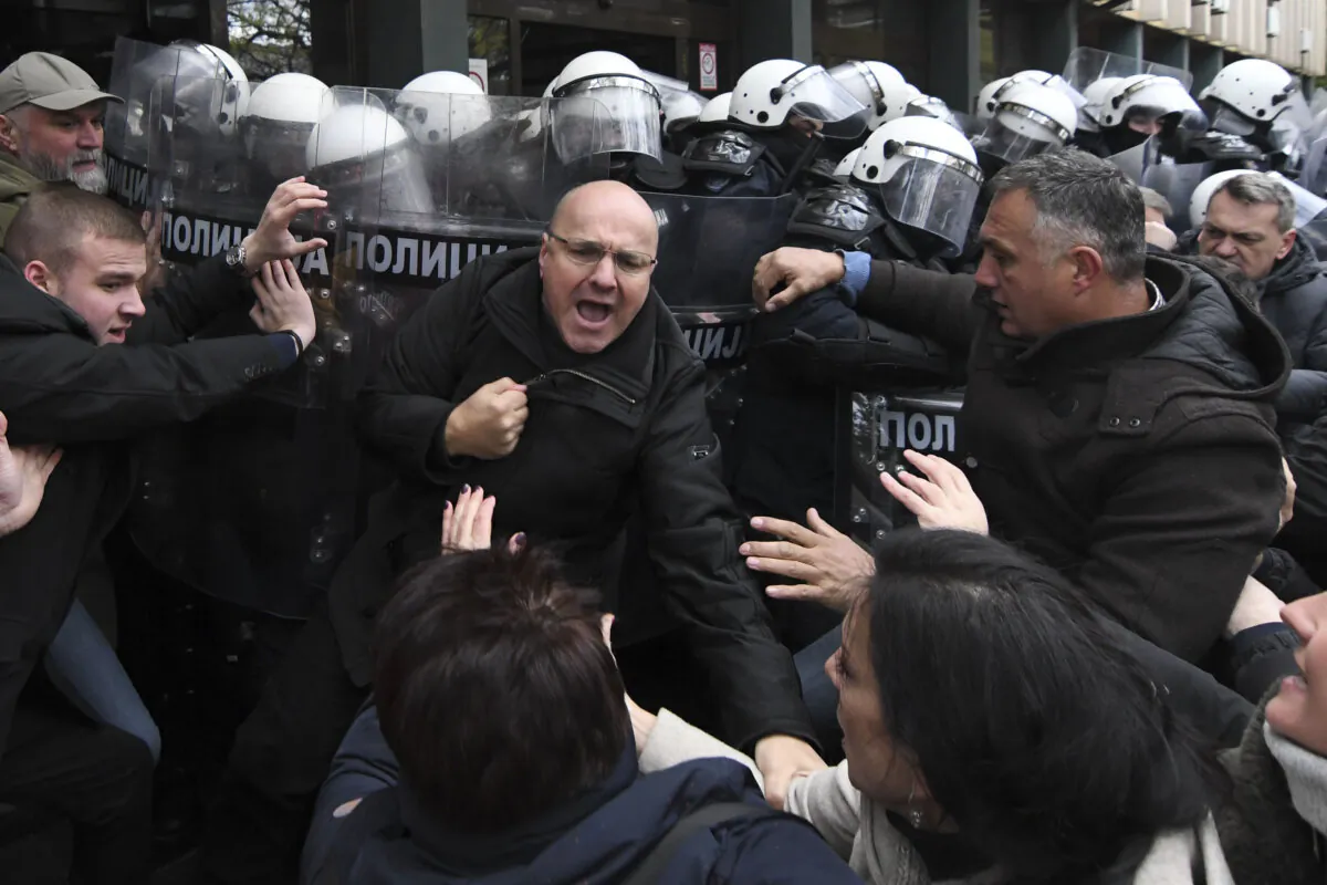 Serbian police officers scuffled with opposition protesters demanding arrests over a deadly roof collapse at a railway station in Novi Sad, Serbia, on Nov. 21, 2024. (AP Photo)