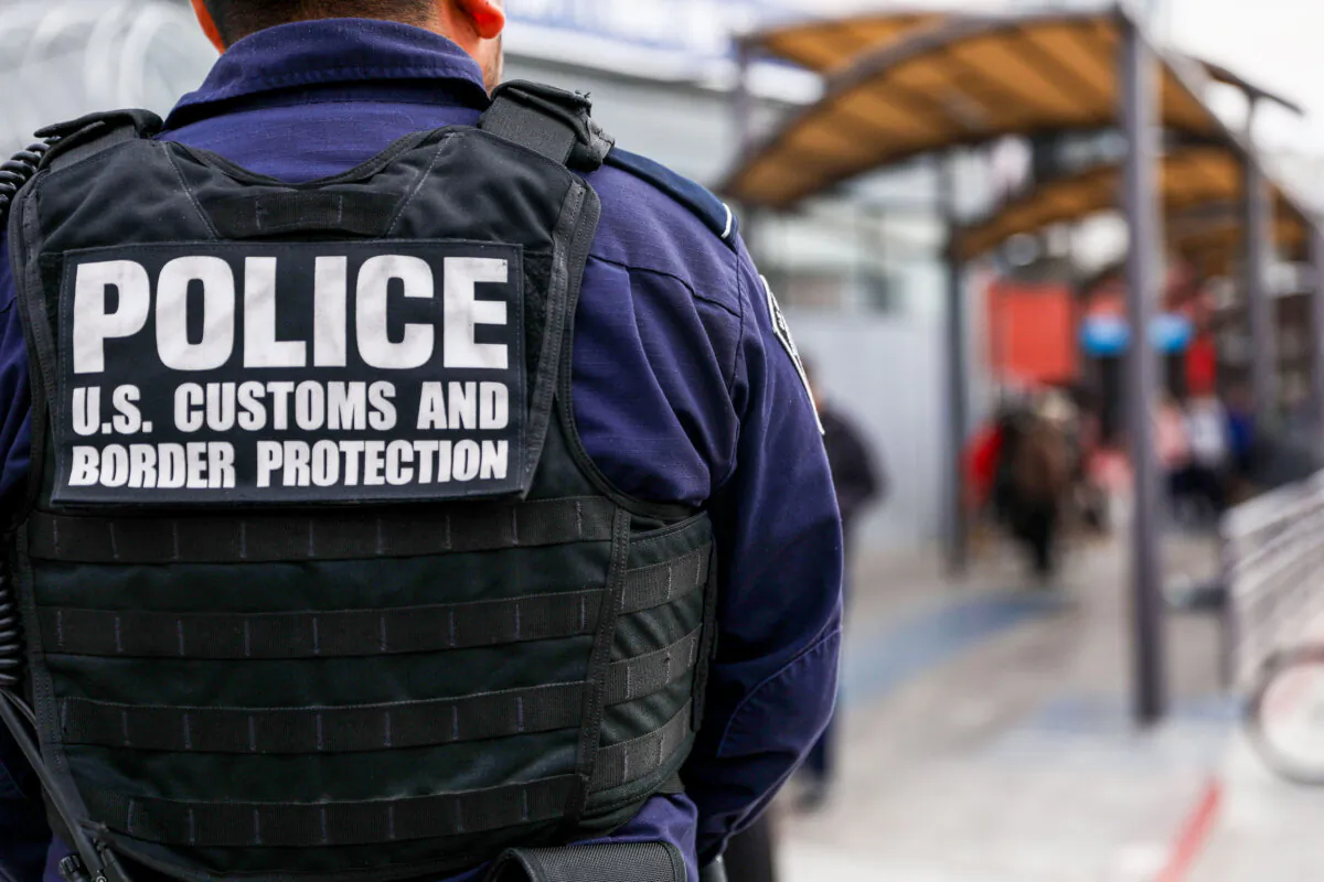 Customs and Border Protection agents check pedestrians as they exit Mexico into the customs area of the United States on the east side of the San Ysidro port of entry in Tijuana, Mexico, on Nov. 19, 2018. (Charlotte Cuthbertson/The Epoch Times)