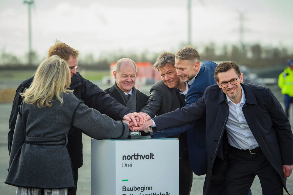 (L–R) Swedish Ambassador to Germany Veronika Wand Danielsson, Schleswig-Holstein Minister-President Daniel Günther, German Chancellor Olaf Scholz, German Vice Chancellor Robert Habeck, Northvolt CEO Peter Carlsson, and Northvolt-Germany CEO Christofer Haux push a button for the new Northvolt electric car battery gigafactory in Lohe-Rickelshof, Germany, on March 25, 2024. (Gregor Fischer/Getty Images)