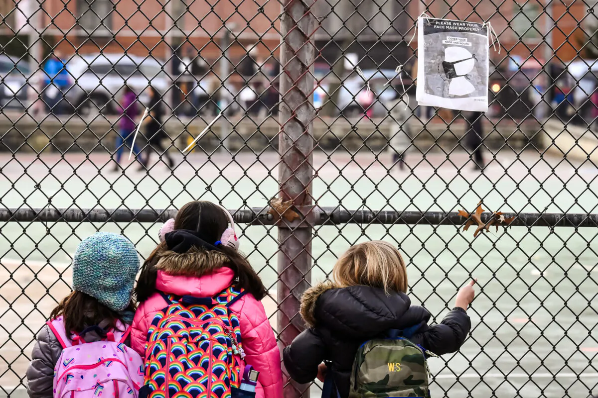 Children look at their school grounds as they wait for class in the Brooklyn borough of New York City on Dec. 7, 2020. (Angela Weiss/AFP via Getty Images)