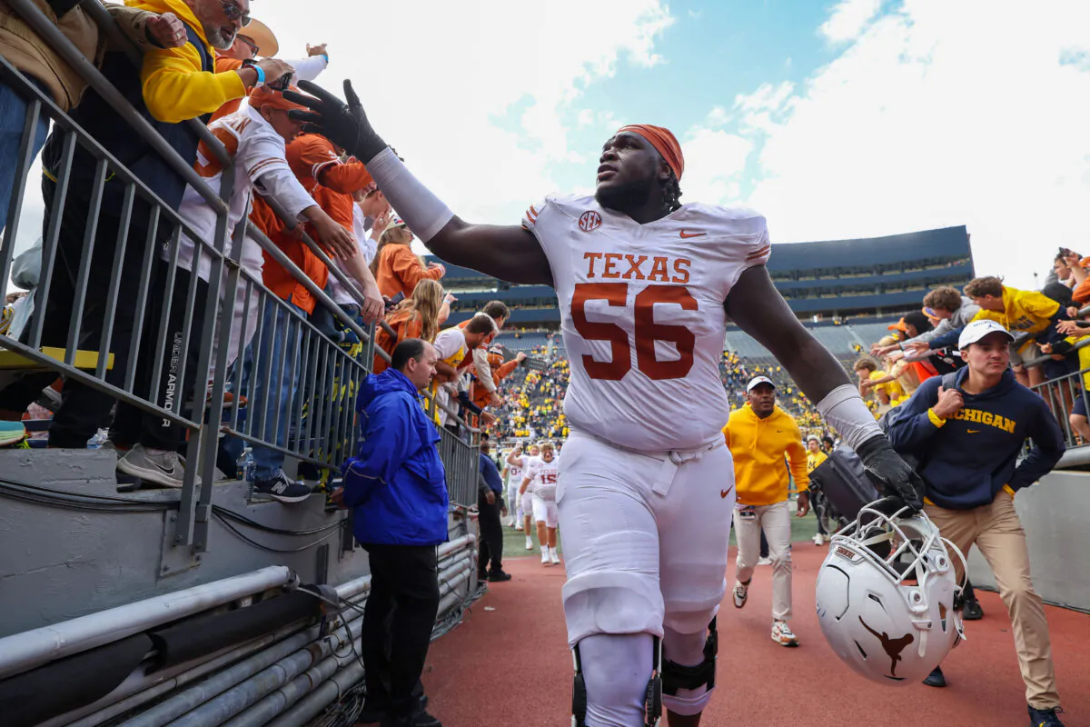 Cameron Williams #56 of the Texas Longhorns greets fans after a 31–12 victory against the Michigan Wolverines at Michigan Stadium in Ann Arbor, Michigan, on Sept. 7, 2024. (Gregory Shamus/Getty Images)